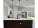 Bright kitchen features white cabinets, quartz counters, stainless appliances, and backyard view through sliding glass door at 2246 Sw 167Th Pl, Ocala, FL 34475