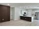 Modern, open kitchen with white cabinetry, stainless steel appliances, and decorative wood slat accent wall at 2246 Sw 167Th Pl, Ocala, FL 34475