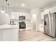 Well-lit kitchen with stainless steel refrigerator, sleek appliances, and white cabinets at 2246 Sw 167Th Pl, Ocala, FL 34475