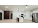 Bright open-concept living area and kitchen with white cabinets and stainless steel refrigerator at 2246 Sw 167Th Pl, Ocala, FL 34475