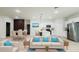Bright and open living room featuring modern furnishings and an adjacent kitchen with white cabinetry at 2246 Sw 167Th Pl, Ocala, FL 34475