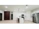 Bright open-concept living area and kitchen with white cabinets and stainless steel refrigerator at 2246 Sw 167Th Pl, Ocala, FL 34475