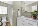 Stylish bathroom featuring marble counters, white vanity, and tiled shower/bath at 2251 Chippewa Trl, Maitland, FL 32751