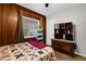 Cozy bedroom featuring wood-paneled walls, a quilted bed, and ample natural light at 2251 Chippewa Trl, Maitland, FL 32751