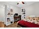 A clean bedroom featuring built-in white storage shelves, a desk, and decorative bedding at 2251 Chippewa Trl, Maitland, FL 32751