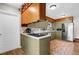 A cozy kitchen with a breakfast bar, olive green cabinets and stainless steel appliances at 2251 Chippewa Trl, Maitland, FL 32751