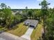 This is an aerial view of a modern home with a long driveway and large front yard at 2483 Sw 163Rd Pl, Ocala, FL 34473