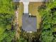 Aerial view of the roof, driveway and front yard surrounded by lush trees at 2483 Sw 163Rd Pl, Ocala, FL 34473