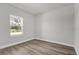 Light and airy bedroom features a large window that allows natural light into the space and wood-look flooring at 2483 Sw 163Rd Pl, Ocala, FL 34473