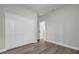 Bedroom with wood-look floors features a closet and bright natural light at 2483 Sw 163Rd Pl, Ocala, FL 34473