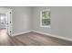 Bright bedroom featuring a view of the outdoors through a large window and light, wood-look floors at 2483 Sw 163Rd Pl, Ocala, FL 34473