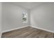 Bright bedroom with wood-look flooring and a window offering an outdoor view at 2483 Sw 163Rd Pl, Ocala, FL 34473