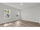 Bedroom with wood-look floors features bright natural light from two windows at 2483 Sw 163Rd Pl, Ocala, FL 34473