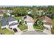 Aerial view of a single-story home with well-manicured lawn, two-car garage, and solar panels, nestled in a lush neighborhood at 2614 Brookshire Ct, Kissimmee, FL 34746