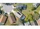 Aerial view of a property with a screened-in pool and solar panels surrounded by well-maintained lawns and mature trees at 2614 Brookshire Ct, Kissimmee, FL 34746