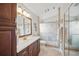 Modern bathroom featuring tile floors, cherry cabinets, and glass enclosed tiled shower at 2614 Brookshire Ct, Kissimmee, FL 34746