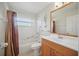 Bright bathroom featuring a shower-tub combo with a tile surround and modern vanity at 2614 Brookshire Ct, Kissimmee, FL 34746