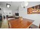 Dining area with a wooden table and pendant lighting, adjacent to the kitchen at 2614 Brookshire Ct, Kissimmee, FL 34746