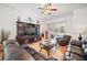 Spacious living room featuring dark leather furniture, wood flooring, and a ceiling fan at 2614 Brookshire Ct, Kissimmee, FL 34746