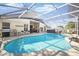 Sparkling swimming pool with a screened enclosure and ample deck space for entertaining at 2614 Brookshire Ct, Kissimmee, FL 34746