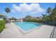 Community pool featuring clear blue water and a surrounding deck and garden at 2614 Brookshire Ct, Kissimmee, FL 34746