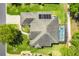 Aerial shot of house with screened-in pool, solar panels, and landscaped yard at 27127 Stoney Brook Dr, Leesburg, FL 34748