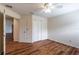 This bedroom offers wood floors, neutral walls, and a ceiling fan for comfortable living at 27127 Stoney Brook Dr, Leesburg, FL 34748