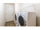 This well-equipped laundry room features a washer, dryer, and storage shelving at 27127 Stoney Brook Dr, Leesburg, FL 34748