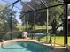 Enjoy the view from this screened-in pool area, perfect for relaxing and entertaining at 27127 Stoney Brook Dr, Leesburg, FL 34748