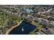 Beautiful aerial view of a neighborhood with houses surrounding a scenic lake and lush trees at 2732 Aloma Oaks Dr, Oviedo, FL 32765