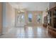 The expansive open floor plan shows the foyer with glass front doors, chandelier and front windows at 2732 Aloma Oaks Dr, Oviedo, FL 32765