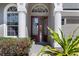 Elegant front entrance with double doors, decorative glass, and lush landscaping at 2732 Aloma Oaks Dr, Oviedo, FL 32765