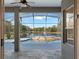 Covered outdoor patio overlooking a screened in pool and beautiful lake at 2732 Aloma Oaks Dr, Oviedo, FL 32765