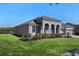 Lovely single-story house showing the backyard with mature landscaping backing up to a pond at 2732 Aloma Oaks Dr, Oviedo, FL 32765