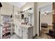 Bright bathroom featuring a vanity with storage, large mirror, and an open doorway to the bedroom at 3038 Woolridge Dr, Orlando, FL 32837