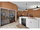 Open kitchen showcasing white cabinets, a copper sink, and views into the living spaces at 3038 Woolridge Dr, Orlando, FL 32837