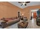 Cozy living room with neutral tile floors, ceiling fan, and comfortable furnishings at 3038 Woolridge Dr, Orlando, FL 32837