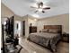 Spacious main bedroom featuring a ceiling fan, neutral walls, and an ensuite bathroom at 3038 Woolridge Dr, Orlando, FL 32837