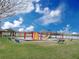 Community playground with slides, swings, and climbing structures offers fun for children in a well maintained green space at 3038 Woolridge Dr, Orlando, FL 32837