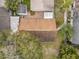 Birds-eye view of a house with brown roof, shed, small backyard and trees at 310 Sunvista Ct, Sanford, FL 32773