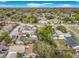 Aerial shot of a quiet neighborhood with mature trees, landscaped yards, and community pool under a sunny blue sky at 310 Sunvista Ct, Sanford, FL 32773