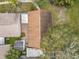 Aerial view of the brown roof, small backyard, and trees at 310 Sunvista Ct, Sanford, FL 32773