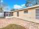 View of the backyard, with brick-paver patio and screened-in porch at 310 Sunvista Ct, Sanford, FL 32773