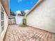 Enclosed backyard featuring brick pavers, landscaping, and a storage shed at 310 Sunvista Ct, Sanford, FL 32773