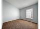 Well-lit bedroom with a neutral color scheme, plush carpet, and a window at 310 Sunvista Ct, Sanford, FL 32773