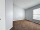 Cozy bedroom featuring neutral walls and carpet, with natural light from a window at 310 Sunvista Ct, Sanford, FL 32773