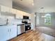 Modern kitchen featuring stainless steel appliances, wooden floors and white cabinets at 310 Sunvista Ct, Sanford, FL 32773