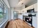 Well-lit kitchen with stainless steel appliances, wooden floors and neutral cabinets at 310 Sunvista Ct, Sanford, FL 32773