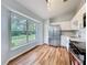 Bright kitchen with stainless steel appliances, white cabinets and wooden floors at 310 Sunvista Ct, Sanford, FL 32773