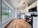 Bright kitchen with stainless steel appliances, white cabinets and wooden floors at 310 Sunvista Ct, Sanford, FL 32773